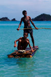 Nacula Island, Yasawa group, Fiji: pair boys on an improvised log raft near Mala Kati Village - photo by C.Lovell