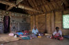 Nacula Island, Yasawa group, Ba Province, Fiji: interior of chief's house in Mala Kati Village  people on floor - bure interior - photo by C.Lovell