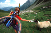 Chamonix, Haute-Savoi, Rhne-Alpes, France: a mountainbiker shares his water bottle with a sheep - Tour du Mont Blanc trail - photo by S.Egeberg
