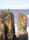 Franz Josef Land - Wilzcek Land Island: man at cliff edge (photo by Bill Cain)