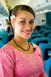 Faa'a International Airport, Tahiti, French Polynesia: a Air Tahiti Nui airlines hostess wearing traditional ethnic and cultural attire of Tahiti - photo by D.Smith