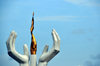 Libreville, Estuaire Province, Gabon: the Flame of Peace sculpture - white hands protect a golden flame - Flamme de la Paix - boulevard Triomphal El Hadj Omar Bongo- photo by M.Torres