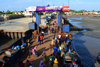 Barra, The Gambia: ferry terminal pier - passengers leave the ferry, while trucks, mostly from Senegal, wait their turn to cross the River Gambia to Banjul - photo by M.Torres