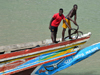 Barra, The Gambia: Gambian sailors - fishermen preparing the anchor on the bow of a traditional wooden fishing boat - River Gambia estuary - photo by M.Torres