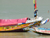 Barra, The Gambia: colorful bows of traditional wooden fishing boats of the River Gambia estuary - photo by M.Torres