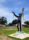 Albreda, Gambia: Emancipation Statue, slavery sculpture with 'never again' at the base - broken chains, globe head and oddly the Berber symbol on the chest - photo by M.Torres