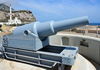 Gibraltar: gun at Harding's Battery, Europa Point, behind it is the Sunni Mosque of The Custodian of the The Holy Mosques -  photo by M.Torres