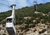 Gibraltar: cable car gondola reaching the lower station - hillside view - photo by M.Torres