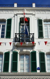 Gibraltar: balcony with Swiss flag on Main Street - Turicum Bank - photo by M.Torres