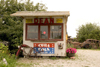Fr island: Dean's kiosk cum scrap yard - Cuba Cola - rusting cars and bike - photo by C.Schmidt