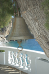 Greece, Karpathos, KyraPanagia: church bell hanging in tree and Kyra Panagia chapel overlooking the homonymous beach - photo by P.Hellander