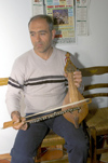 Greece, Karpathos, Olymbos:Karpathian lyra player Nikos Filippakis shows how the traditional island instrument is played - photo by P.Hellander