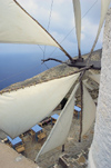 Greece, Karpathos, Olymbos: the sails of the sole surviving working windmill in Olymbos frame the tablesof the Mylos (Mill) Restaurant - photo by P.Hellander