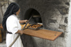 Greece, Karpathos, Olymbos:baking food in the traditional communal oven in northern Karpathos - photo by P.Hellander