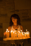 Greece - Paros: young woman lights candles in the Ekatontapyliani Church in Paroikia - photo by D.Smith