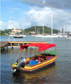 Grenada - St. George's - Carenage harbour - boat with red cover - photo by P.Baldwin