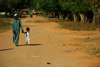 Praia de Varela / Varela beach, Cacheu region, Guinea Bissau / Guin Bissau: Man walking whitd a child, everyday life / Homem a passear com uma criana, vida quotidiana - photo by R.V.Lopes