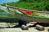 Praia de Varela / Varela beach, Cacheu region, Guinea Bissau / Guin Bissau: Fishermen resting under their boats / Pescadores a descansar, barcos de pesca tradicionais - photo by R.V.Lopes