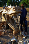 Bissau, Guinea Bissau / Guin Bissau: Bandim quarter, Carnival masks, mask of a dragon and a skull, man/ Bairro Bandim, mscaras de Carnaval, preparao, mscara de um drago, homem - photo by R.V.Lopes