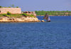 Fort-Libert, Nord-Est Department, Haiti: a fishing boat sails past Fort Dauphin - photo by M.Torres