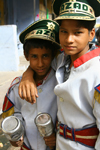 Bundi, Rajasthan, India: boys with maracas and 'Azad' hats - photo by M.Wright