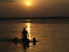 Varanasi, Uttar Pradesh, India: silhouettes bathing in the Ganges river - sunset - photo by J.Hernndez