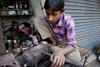 Calcutta / Kolkata, West Bengal, India: child working with metal in the streets - child labour - photo by G.Koelman