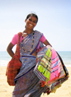 Goa, India: Arambol Beach - the ever smiling, ever insistent, beach textile seller - woman holding pareos - photo by R.Resende