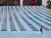 Israel - Shfaim: water park - child alone by the water chutes - blue lines - photo by E.Keren