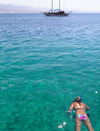 Eilat, South district, Israel: girl snorkeling and tour boat - Gulf of Aqaba - Gulf of Eilat - Mifratz Eilat - photo by E.Keren