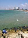 Tel Aviv, Israel: an angler in Yafo looks at the city and the Mediterranean sea - photo by E.Keren