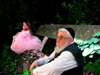 Israel: the ages - conceptual view of old Jew and smal girl in pink dress sitting on a old wooden bench - photo by E.Keren