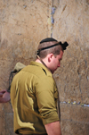 Jerusalem, Israel: an Israeli soldier prays at the Wailing wall - wearing in his head a tefillin or phylactery, a leather box containing parchment with verses from the Torah / Western Wall / the Kotel - muro das lamentaes - Mur des Lamentations - Klagemauer - photo by M.Torres