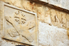 Jerusalem, Israel: Via Dolorosa, Station 5, carving of Franciscan arms with Jerusalem cross - Fransciscan Order symbol - photo by M.Torres