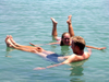 Israel - Dead sea: couple floating - buoyancy caused by high salinity - photo by R.Wallace