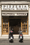 Rome, Italy: mopeds parked outside pizzeria - Galleria Sciarra - photo by I.Middleton