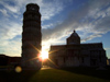 Pisa - Duomo and Pisa tower - silhouetted against the sun - photo by M.Bergsma