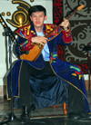Kazakhstan, Almaty: playing a traditional dombra, a long-necked, stringed instrument - photo by M.Torres