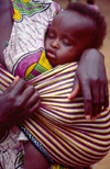 Kenya - Majengo, Mombasa Island, Coast Province: baby sleeping in mother's arms - photo by F.Rigaud