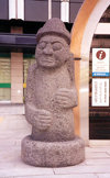 Asia - South Korea - Seoul: sad face -  -  Stone Grandfather  fertility statue - Tol-Harubang from Jeju island / Cheju island - photo by M.Torres