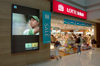 Seoul, South Korea: airport terminal Lotte duty free store with Tiger Woods advertisement for American Express - Lotte sale - Incheon International Airport - photo by C.Lovell