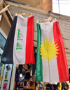 Erbil / Hewler / Arbil / Irbil, Kurdistan, Iraq: flags of Iraq and Kurdistan hang side by side outside a shop in the old town - photo by M.Torres