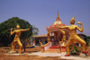 Laos: statues of two war gods in the front of a temple - photo by E.Petitalot