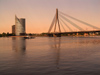 Latvia / Latvija - Riga: dusk on the Daugava - Vansu bridge, a Cable-stayed and the Saules Akmens skyscrapper (photo by J.Kaman)