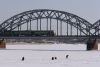 Latvia / Latvija / Lettland - Riga: frozen Daugava - rail bridge - a train heads west - photo by Alex Dnieprowsky