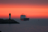 Latvia - Ventspils: the Navalis enters the harbour - lighthouse at sunset (photo by A.Dnieprowsky)