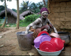 Liberia - Grand Basa County: secret society girl - doing the dishes - domestic chores - photo by M.Sturges