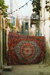 Libya - Tripoli: carpet hanging to close off street for private family celebration (photo by G.Frysinger)