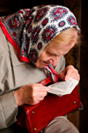 Vilnius, Lithuania: elderly woman reading the Bible in Chapel of the Blessed Mary - photo by J.Pemberton