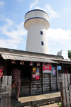 Morondava - Menabe, Toliara province, Madagascar: shop and water tower - photo by M.Torres